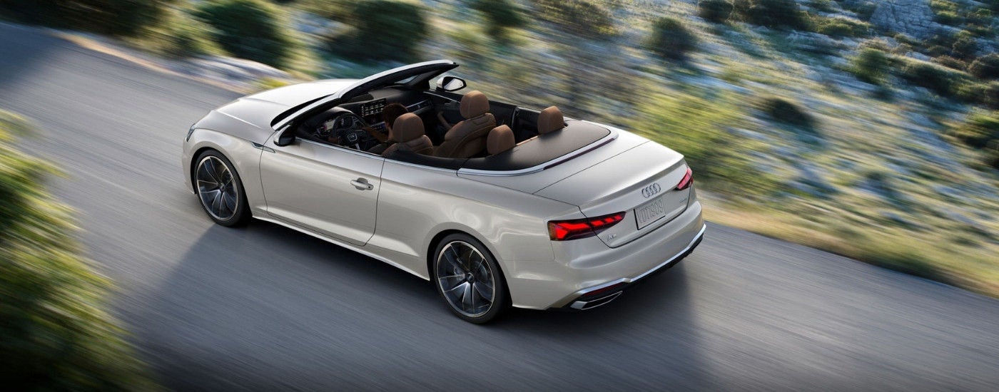 White 2024 Audi A5 Cabriolet driving on a highway